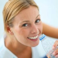 Blond Woman Drinking From Water Bottle